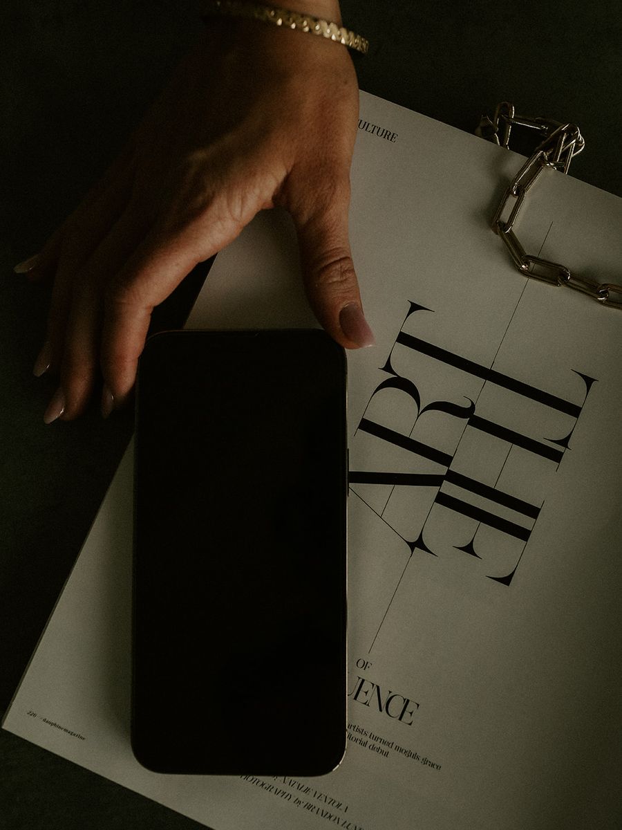 A hand resting on a typographic spread